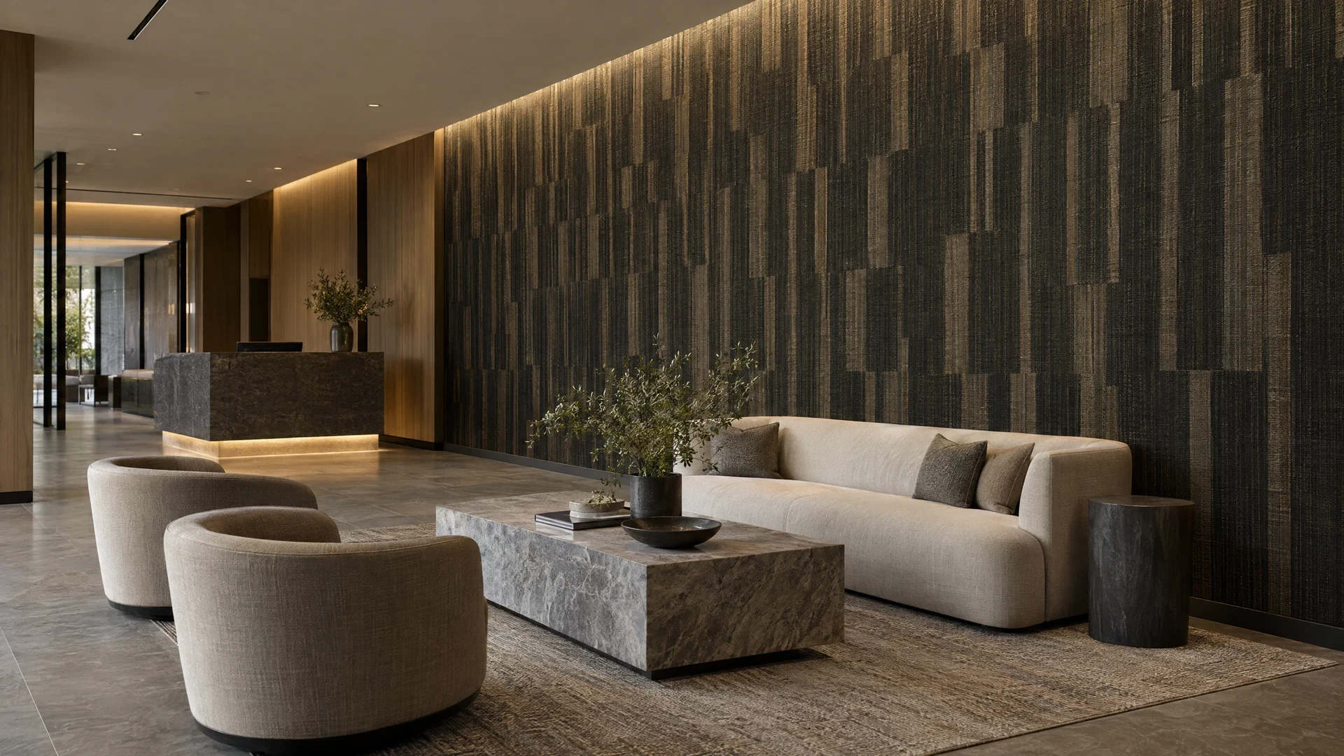 Quiet commercial lounge with charcoal geometric wallcovering, pale wood details and cream seating.